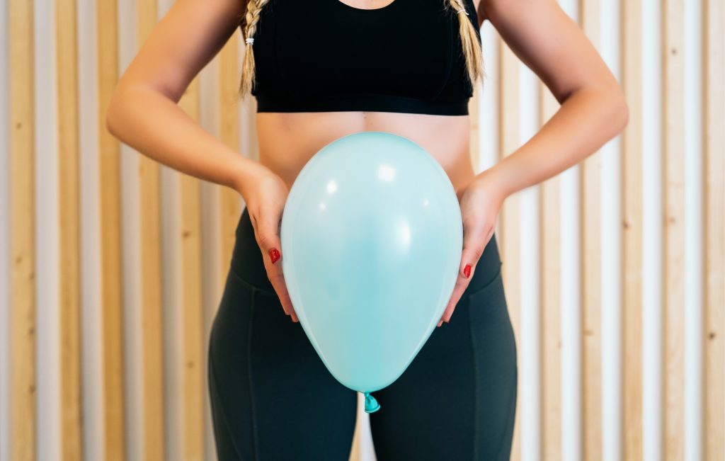 Close Up Of A Young Woman Holding A Balloon To Explain Pelvic Floor Exercises