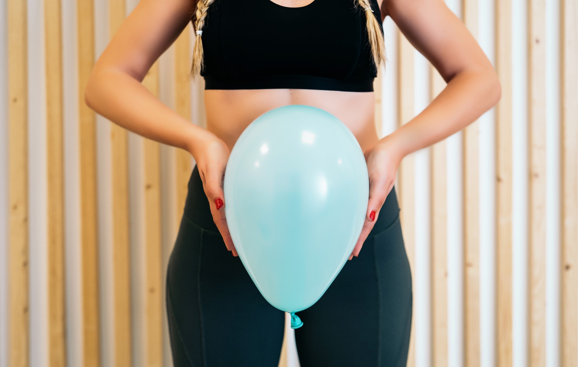 Close Up Of A Young Woman Holding A Balloon To Explain Pelvic Floor Exercises