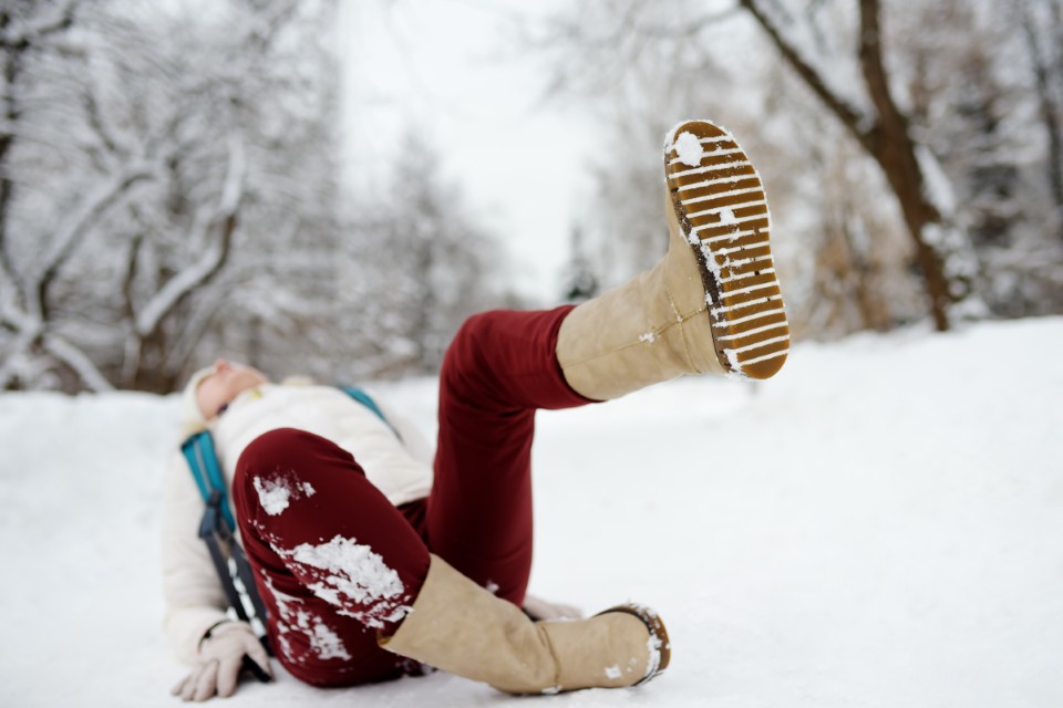 Shot Of Person During Falling In Snowy Winter Park. Woman Slip O